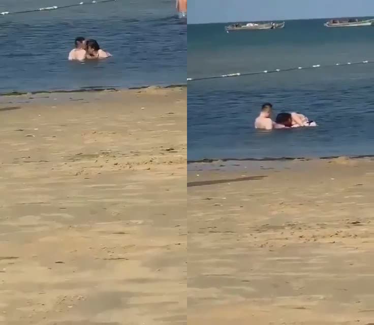 海滩寻求刺激的情侣，公然在浅滩撒狗粮，亲嘴就算了，还掏出鸡巴让女友含进去，看呐口活口活，小孩都走近靠前看乐！